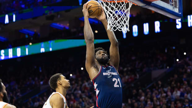 76ers center Joel Embiid scores past San Antonio Spurs center Victor Wembanyama (1) during the first quarter at Wells Fargo Center.